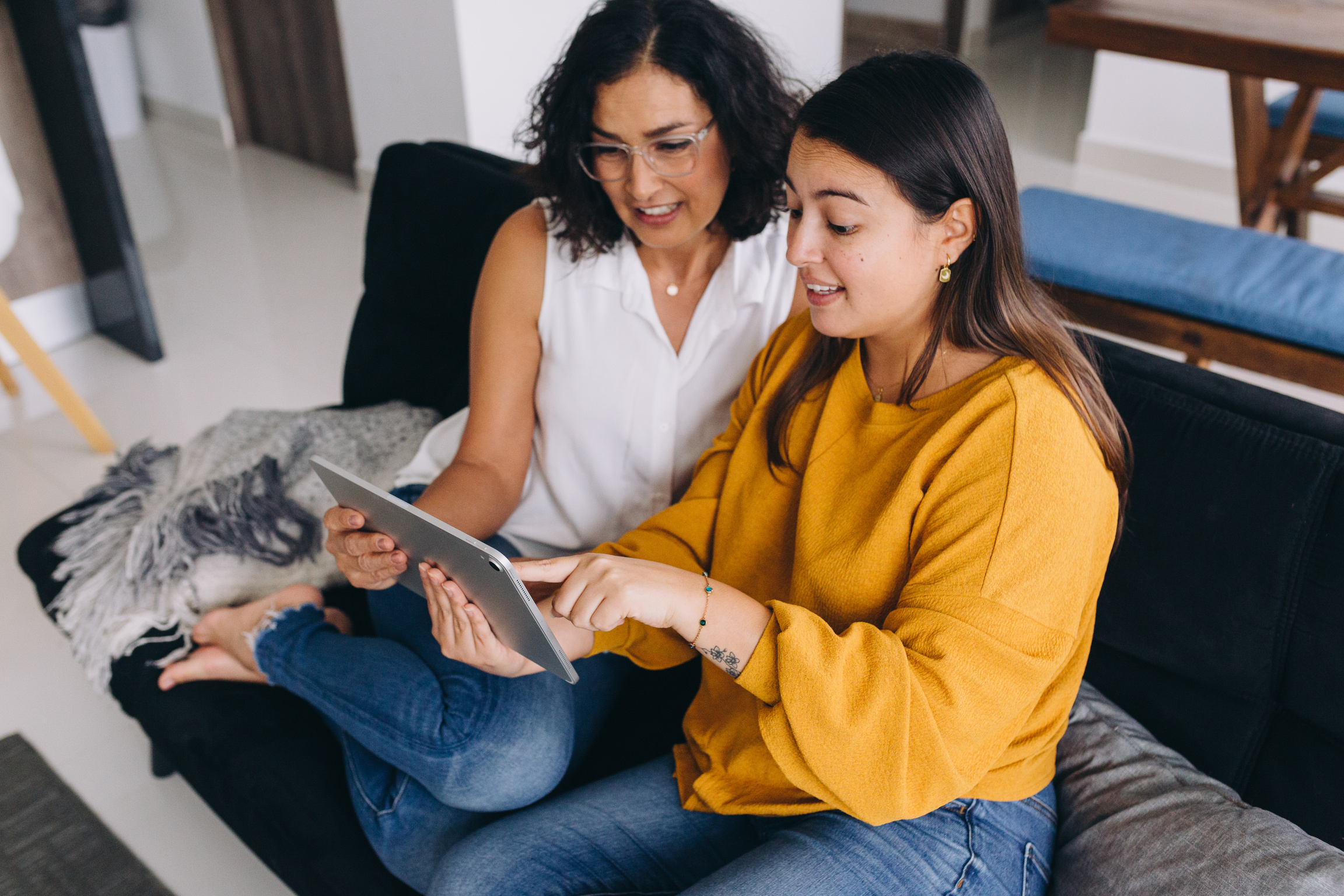 Mother and Daughter Watching Something on Tablet at Home